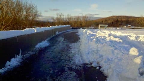 Drone photography of a building with broken rooftop during winter day