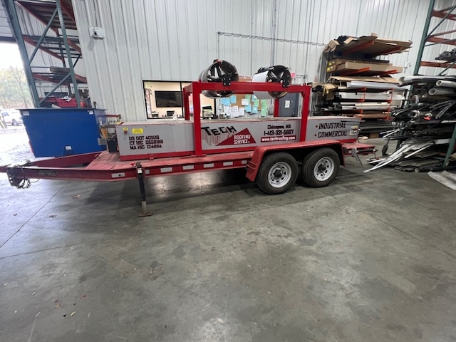 Professional roof technician on top of asphalt shingle roof conducting inspection