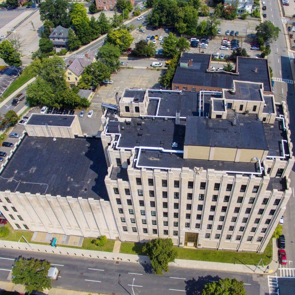 Aerial view of a Carlisle EPDM flat roof replacement completed by Tech Roofing on a commercial building in Worcester, MA.